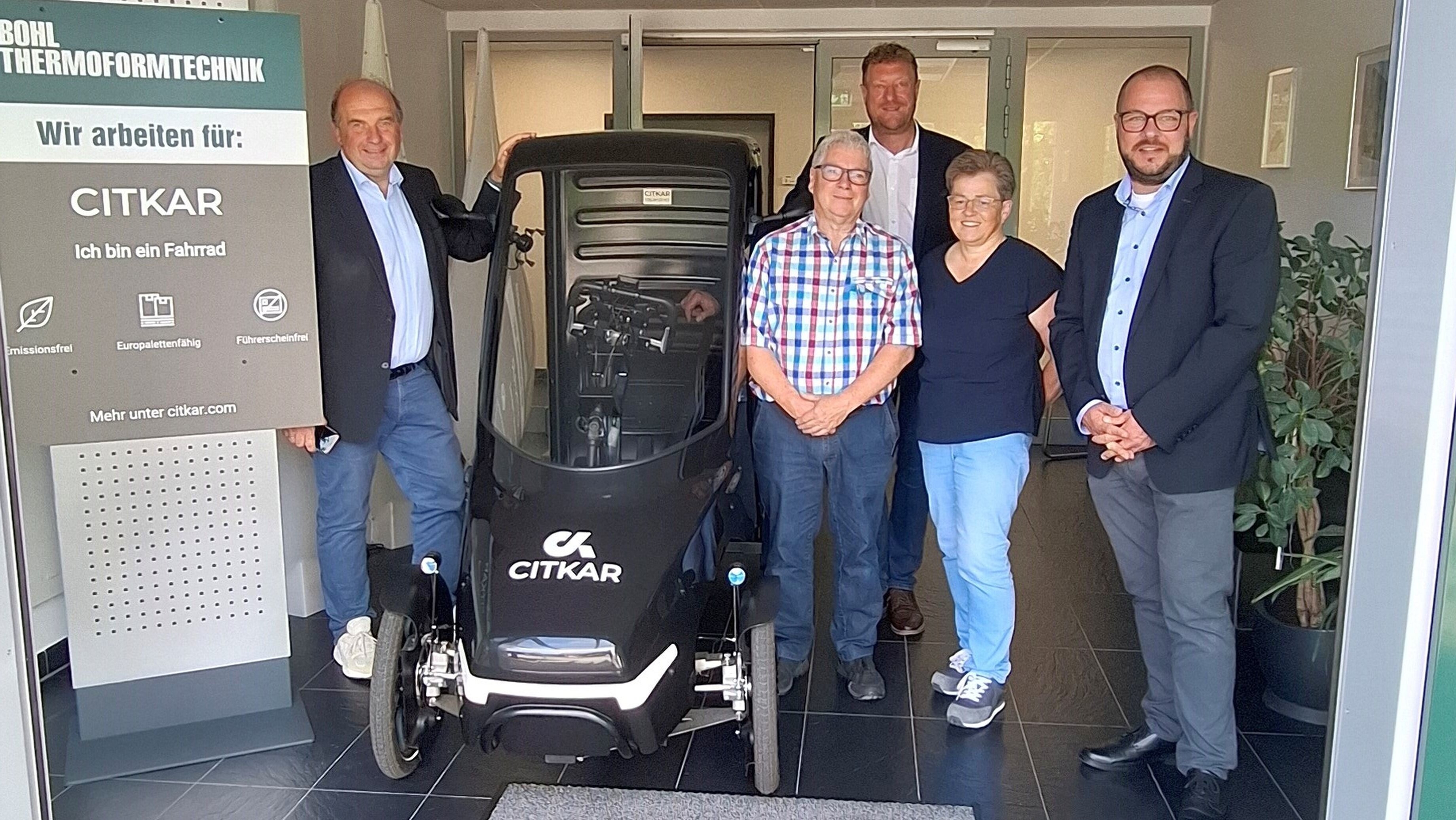 Martin Schmitz, Matthias Bohl, Michael Keilich, Karin Bohl und Sebastian Straubel stehen im Eingangsbereich der Firma Bohl in Wörlsdorf. Zwischen ihnen steht ein Lastenfahrrad.